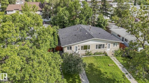 Single-story residence with a dark shingle roof, light-colored siding, and multiple front-facing windows - 16428 88 Avenue Nw, Edmonton, AB - Outdoor