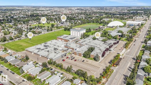 Aerial perspective showcasing a mixed-use urban landscape with commercial and residential structures - 16428 88 Avenue Nw, Edmonton, AB - Outdoor With View