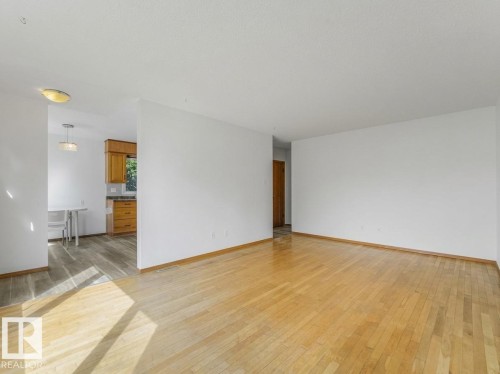 Hardwood flooring throughout the main area - 16428 88 Avenue Nw, Edmonton, AB - Indoor Photo Showing Other Room