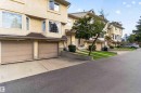 Two-car garage with panel doors and concrete driveway - #28 3645 145 Av Nw, Edmonton, AB  - Outdoor With Facade 