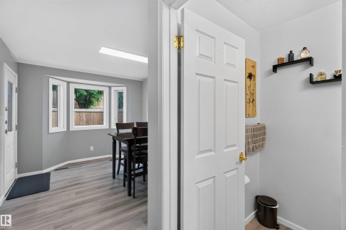 Bay window with white trim, wood-finish flooring, white paneled interior door, and recessed lighting - #28 3645 145 Av Nw, Edmonton, AB - Indoor Photo Showing Other Room