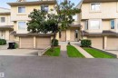 Three-story townhouse exterior with multiple windows, bay windows, and attached garages - #28 3645 145 Av Nw, Edmonton, AB  - Outdoor With Facade 
