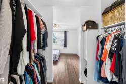 Walk-in closet with built-in shelving and hanging rods - 