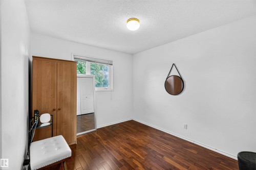 Hardwood-finish flooring, white painted walls, and a single window - #28 3645 145 Av Nw, Edmonton, AB - Indoor Photo Showing Other Room