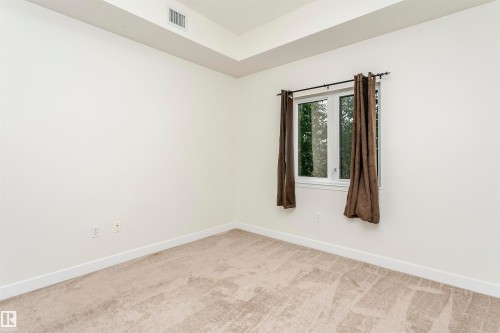 Light-toned wall-to-wall carpeting - #219 10333 112 St Nw, Edmonton, AB - Indoor Photo Showing Other Room