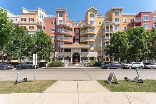 Multi-story stucco exterior with varied architectural elements and multiple balconies featuring glass railings - #219 10333 112 St Nw, Edmonton, AB - Outdoor With Facade