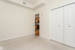 Carpeted flooring, white walls, and bifold closet doors with silver hardware - 