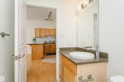 Bathroom vanity with an oval vessel sink, chrome faucet, and speckled countertop - 