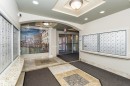 Recessed lighting, decorative ceiling fixture, tiled flooring, built-in mailboxes, glass entry doors - #219 10333 112 St Nw, Edmonton, AB  - Indoor Photo Showing Other Room 