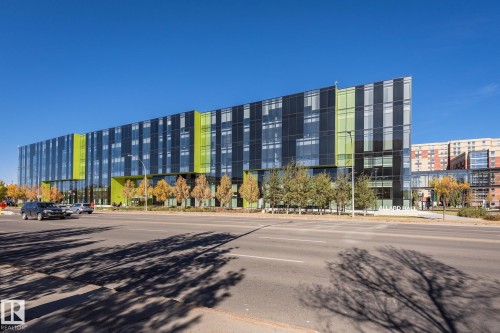 Contemporary multi-story facade featuring extensive glazing and lime green architectural accents - #219 10333 112 St Nw, Edmonton, AB - Outdoor