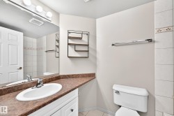 White vanity with a brown countertop, undermount sink, and chrome faucet - 
