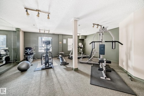 Fitness area with wall-to-wall carpeting, track lighting, and mirrored wall - #331 9704 174 St Nw, Edmonton, AB 