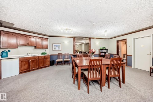 Kitchenette with wood cabinetry and countertop - #331 9704 174 St Nw, Edmonton, AB 