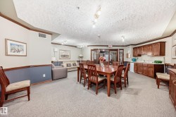 Full kitchen-style cabinetry with a sink, recessed lighting, and glass-paneled double doors - 