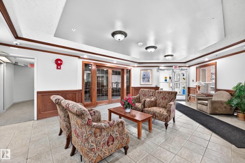 Tiled flooring, wood paneling, wood-frame glass double doors, recessed lighting, and decorative ceiling lights - #331 9704 174 St Nw, Edmonton, AB 