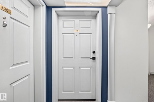 White paneled doors with gold-finish numbering and black hardware - #331 9704 174 St Nw, Edmonton, AB 
