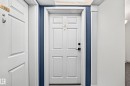 White paneled doors with gold-finish numbering and black hardware - #331 9704 174 St Nw, Edmonton, AB  -  Photo Showing Other Room 
