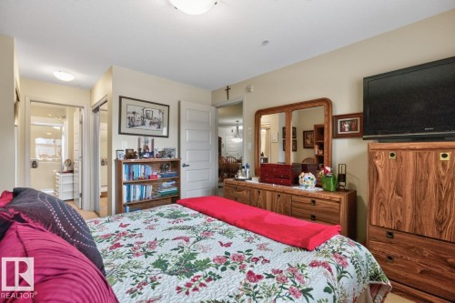 Recessed ceiling lighting, wood-finish flooring, and white paneled doors - #210 7909 71 St Nw, Edmonton, AB - Indoor Photo Showing Bedroom