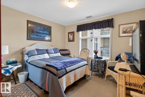 Carpeted flooring paired with neutral wall tones - #210 7909 71 St Nw, Edmonton, AB - Indoor Photo Showing Bedroom