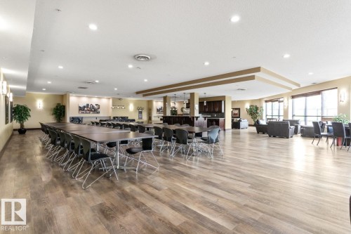 Expansive common area featuring wood-finish flooring, recessed lighting, and large windows - #210 7909 71 St Nw, Edmonton, AB - Indoor Photo Showing Dining Room