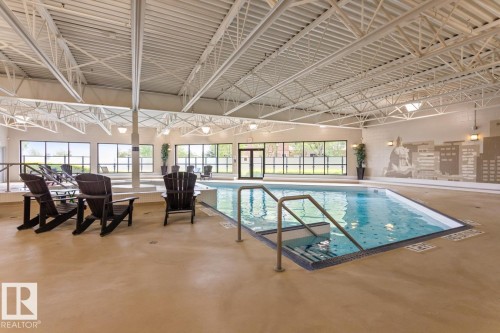 Indoor swimming pool with integrated steps and handrail - #210 7909 71 St Nw, Edmonton, AB - Indoor Photo Showing Other Room With In Ground Pool