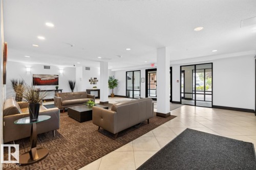 Spacious common area featuring recessed lighting, a neutral color palette, tile flooring, and large glass-paned doors - #210 7909 71 St Nw, Edmonton, AB - Indoor Photo Showing Other Room