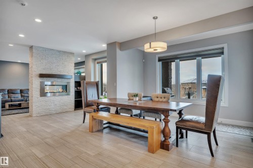 4510 Wingfield Bay Nw, Edmonton, AB - Indoor Photo Showing Dining Room With Fireplace