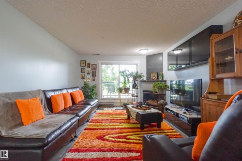 #128 279 Suder Greens Dr Nw, Edmonton, AB - Indoor Photo Showing Living Room With Fireplace