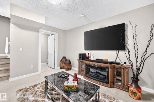 6136 Rosenthal Way Nw, Edmonton, AB - Indoor Photo Showing Living Room With Fireplace