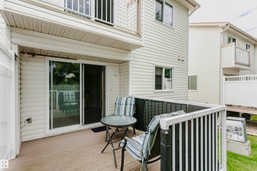 Private outdoor patio with composite decking and white privacy fencing - #42 9630 176 St Nw, Edmonton, AB - Outdoor With Deck Patio Veranda With Exterior