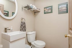 Pedestal sink with a rectangular basin, chrome faucet, and oval mirror - 
