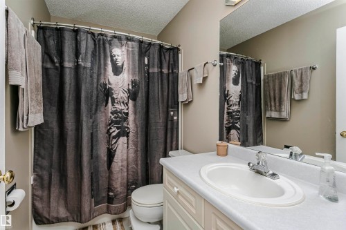 Single vanity with an integrated sink, polished chrome faucet, and storage cabinetry - #42 9630 176 St Nw, Edmonton, AB - Indoor Photo Showing Bathroom