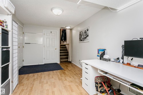 Wood-finish flooring with white walls and a white ceiling - #42 9630 176 St Nw, Edmonton, AB - Indoor Photo Showing Other Room