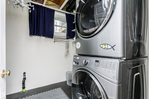 Laundry area with white walls and dark flooring - #42 9630 176 St Nw, Edmonton, AB - Indoor Photo Showing Laundry Room