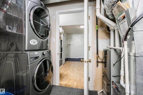Stackable washer and dryer units - #42 9630 176 St Nw, Edmonton, AB - Indoor Photo Showing Laundry Room