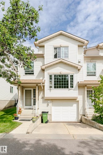 White siding exterior with a prominent bay window - #42 9630 176 St Nw, Edmonton, AB - Outdoor With Facade