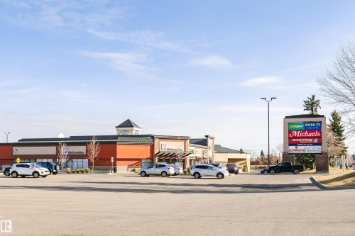 Commercial complex featuring a prominent pylon sign and ample surface parking - #42 9630 176 St Nw, Edmonton, AB - Outdoor