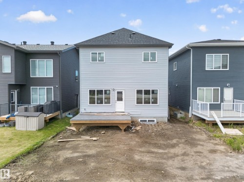 Light-toned horizontal siding exterior with a dark shingle roof - 8915 Mayday Way Sw, Edmonton, AB - Outdoor With Deck Patio Veranda With Exterior