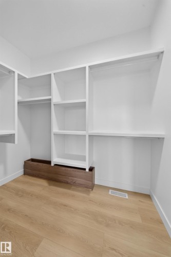 Built-in shelving and hanging rods for organized storage - 8915 Mayday Way Sw, Edmonton, AB - Indoor With Storage