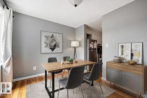 Hardwood flooring, light gray wall finishes, recessed ceiling light, and white window treatments - #44 1415 62 St Nw, Edmonton, AB - Indoor Photo Showing Dining Room