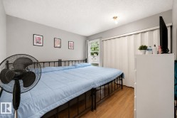 Wood-finish flooring, light gray wall paint, and a built-in accordion door wardrobe - 