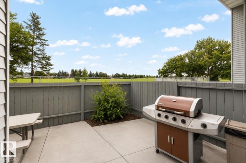 Private concrete patio with a wooden privacy fence - #44 1415 62 St Nw, Edmonton, AB - Outdoor With Deck Patio Veranda