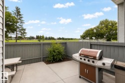 Private concrete patio with a wooden privacy fence - 