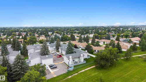 Residential area featuring a mix of mature trees, green spaces, and a clear blue sky - #44 1415 62 St Nw, Edmonton, AB - Outdoor With View