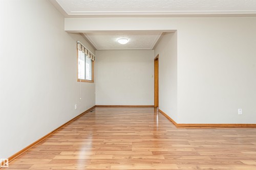 Recessed ceiling light fixture, wood-finish flooring, and a single window with wood framing - 11139 62 Avenue Nw, Edmonton, AB - Indoor Photo Showing Other Room