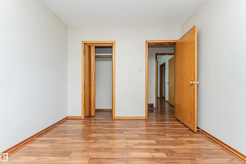 Wood-finish flooring with coordinating wood trim and doors - 11139 62 Avenue Nw, Edmonton, AB - Indoor Photo Showing Other Room
