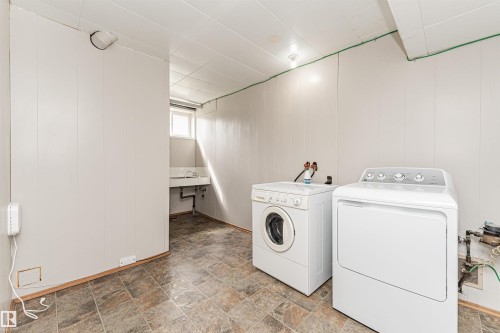 Utility space featuring a window, tile flooring, and white paneled walls - 11139 62 Avenue Nw, Edmonton, AB - Indoor Photo Showing Laundry Room