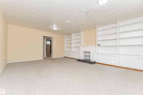 Expansive room featuring wall-to-wall carpeting and built-in shelving - 11139 62 Avenue Nw, Edmonton, AB - Indoor Photo Showing Other Room