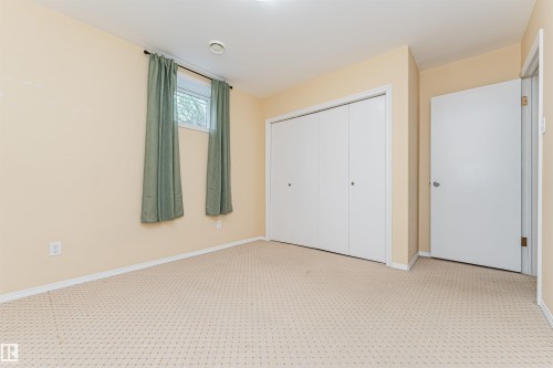 Textured carpet flooring, neutral-toned walls, white trim, recessed ceiling light, and a single window - 11139 62 Avenue Nw, Edmonton, AB - Indoor Photo Showing Other Room