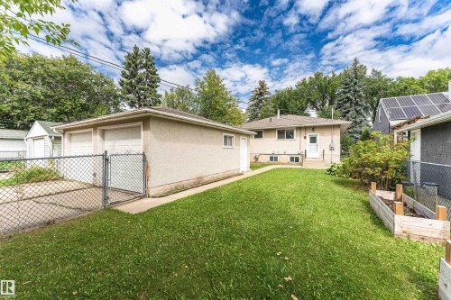Expansive rear lawn, two-car detached garage, exterior garden beds, mature perimeter landscaping, and a side entry - 11139 62 Avenue Nw, Edmonton, AB - Outdoor